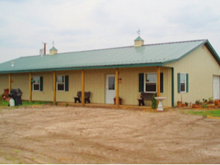 A large metal building serves as the clubhouse at the McPherson RV Ranch & Horse Motel.