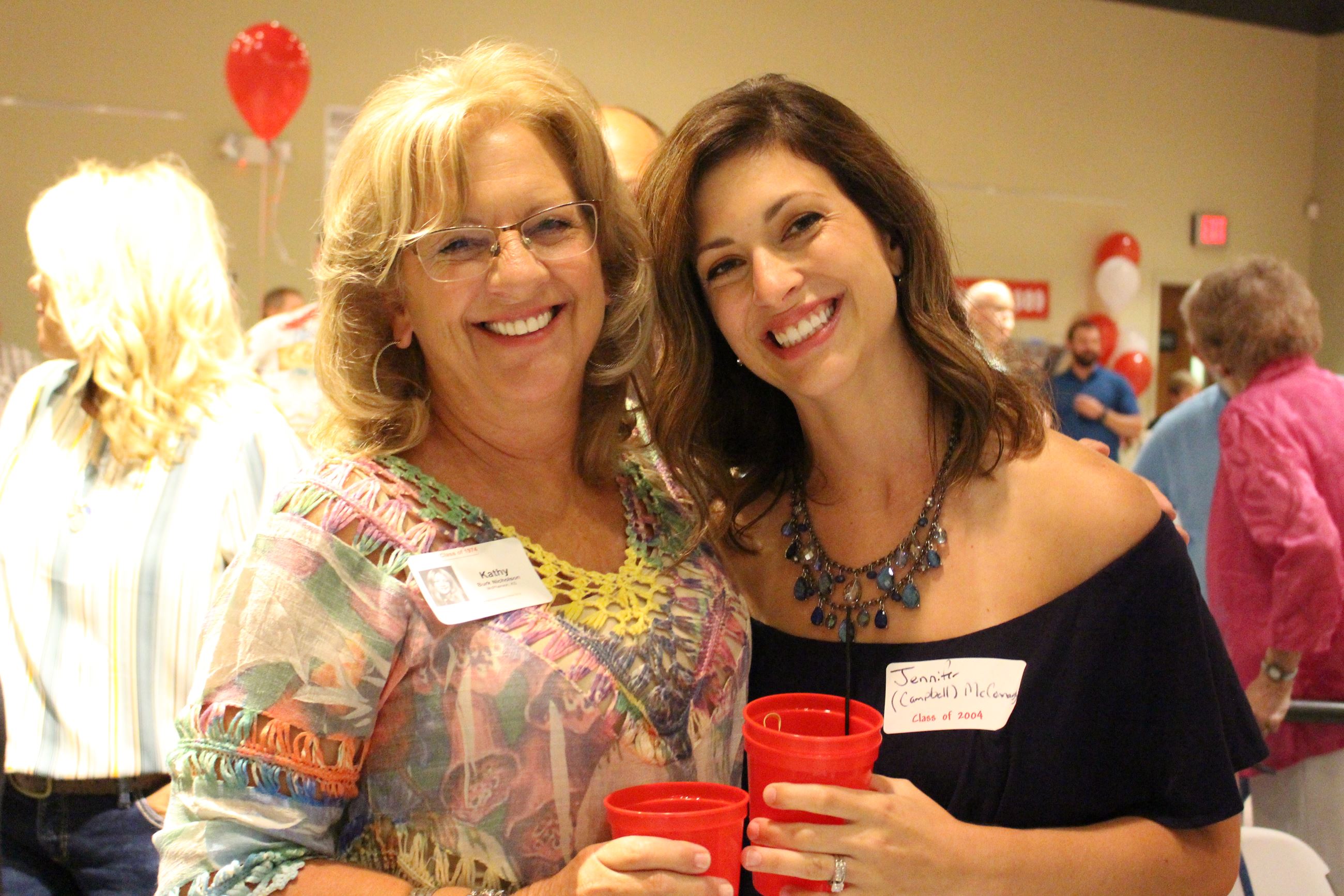 Two women celebrate together at the MHS class reunion